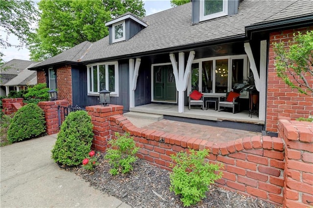 1400 SW 8th Ter, Lees Summit, MO 64081 - property entrance featuring a shingled roof, covered porch, and brick siding