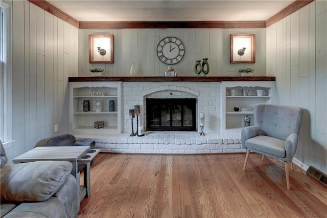 1400 SW 8th Ter, Lees Summit, MO 64081 - sitting room featuring wood finished floors, wood walls, and a fireplace