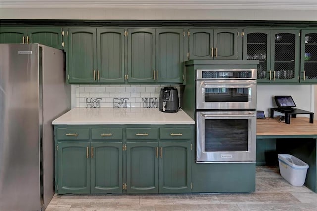 1400 SW 8th Ter, Lees Summit, MO 64081 - kitchen with green cabinets, appliances with stainless steel finishes, light countertops, light wood-style flooring, and crown molding