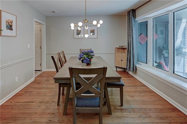 1400 SW 8th Ter, Lees Summit, MO 64081 - dining space with light wood finished floors, a chandelier, and baseboards