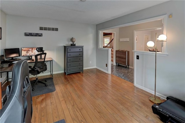 1400 SW 8th Ter, Lees Summit, MO 64081 - office with wood finished floors, baseboards, and a textured ceiling