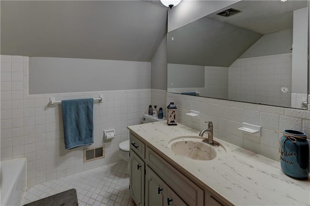 1400 SW 8th Ter, Lees Summit, MO 64081 - full bath with tile walls, lofted ceiling, a bath, tile patterned flooring, and vanity