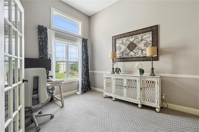 carpeted office with baseboards, plenty of natural light, and french doors