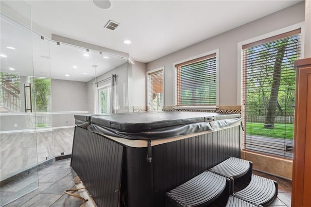 interior space featuring baseboards, stone finish flooring, recessed lighting, and visible vents
