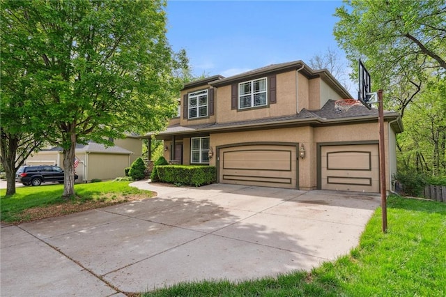 traditional-style home featuring an attached garage, stucco siding, driveway, and a front yard