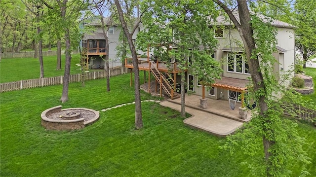 view of yard with a patio, a fenced backyard, stairs, and a deck