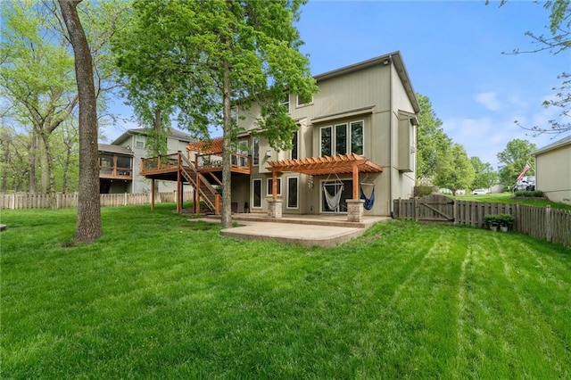 rear view of house with a lawn, a deck, a patio area, a fenced backyard, and a pergola