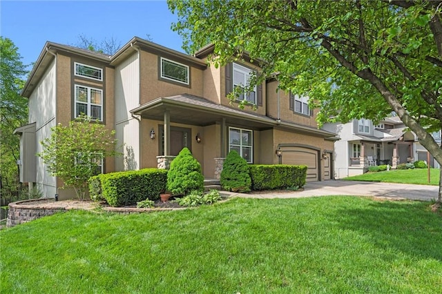view of front of house with an attached garage, concrete driveway, stucco siding, and a front yard
