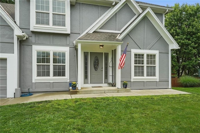 3945 SW Batten Dr, Lees Summit, MO 64082 - view of front of home with stucco siding, a front lawn, and a shingled roof