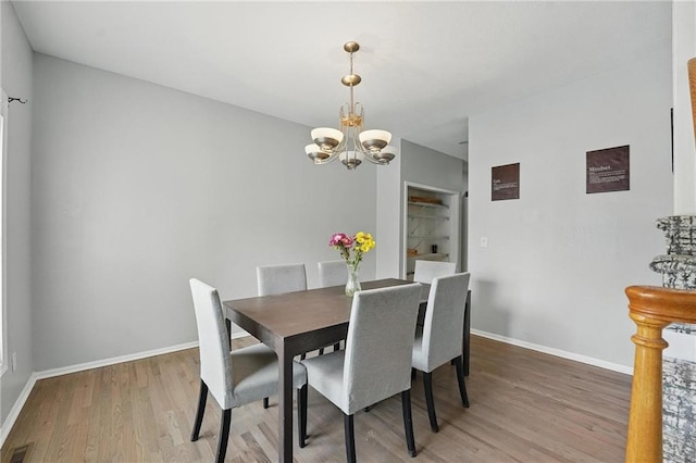 3945 SW Batten Dr, Lees Summit, MO 64082 - dining area featuring a chandelier, light wood-style floors, and baseboards