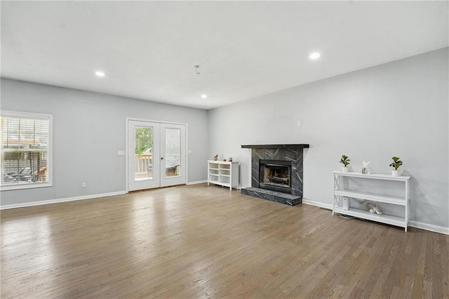 3945 SW Batten Dr, Lees Summit, MO 64082 - unfurnished living room featuring plenty of natural light, a premium fireplace, wood finished floors, baseboards, and recessed lighting