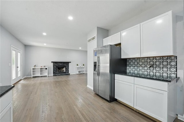 3945 SW Batten Dr, Lees Summit, MO 64082 - kitchen featuring stainless steel fridge with ice dispenser, tasteful backsplash, white cabinetry, light wood finished floors, and recessed lighting