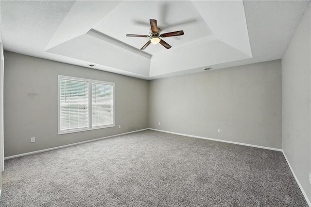 3945 SW Batten Dr, Lees Summit, MO 64082 - carpeted empty room featuring a tray ceiling, a ceiling fan, and baseboards
