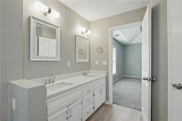 3945 SW Batten Dr, Lees Summit, MO 64082 - full bathroom featuring double vanity, wood finished floors, and baseboards