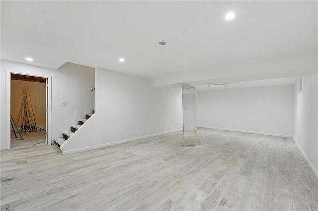3945 SW Batten Dr, Lees Summit, MO 64082 - finished below grade area with stairs, light wood-style floors, recessed lighting, and baseboards