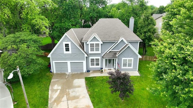 3945 SW Batten Dr, Lees Summit, MO 64082 - view of front facade with a chimney, concrete driveway, roof with shingles, a garage, and board and batten siding