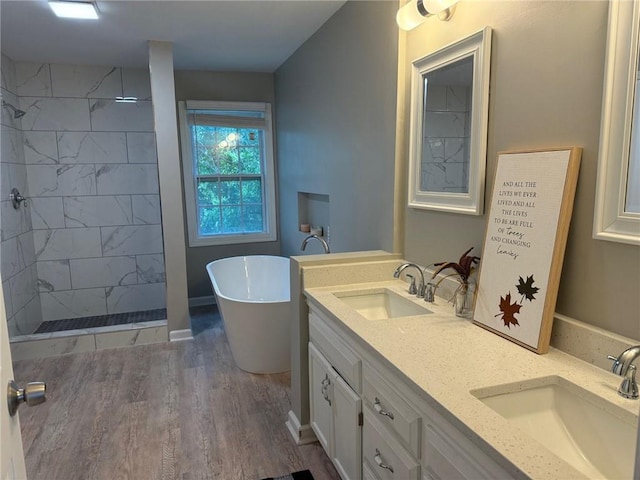 3945 SW Batten Dr, Lees Summit, MO 64082 - full bath with a freestanding tub, double vanity, a tile shower, and wood finished floors