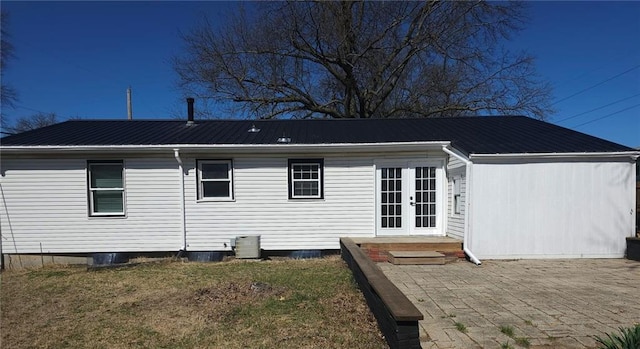 11115 E 35th Ter S, Independence, MO 64052 - rear view of house with french doors, metal roof, central AC, and a patio area