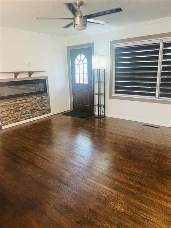 11115 E 35th Ter S, Independence, MO 64052 - unfurnished living room with crown molding, a ceiling fan, wood finished floors, a textured ceiling, and a fireplace