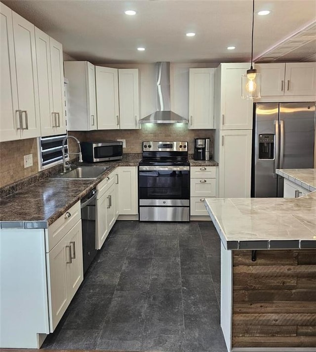 11115 E 35th Ter S, Independence, MO 64052 - kitchen featuring appliances with stainless steel finishes, wall chimney exhaust hood, a sink, white cabinets, and tasteful backsplash