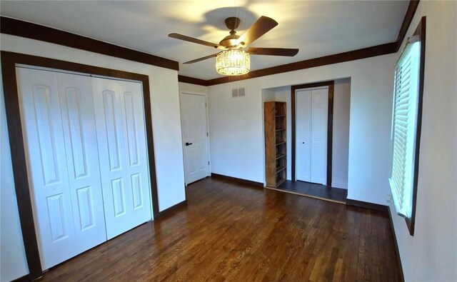 11115 E 35th Ter S, Independence, MO 64052 - unfurnished bedroom with dark wood-style flooring, baseboards, a ceiling fan, and a closet