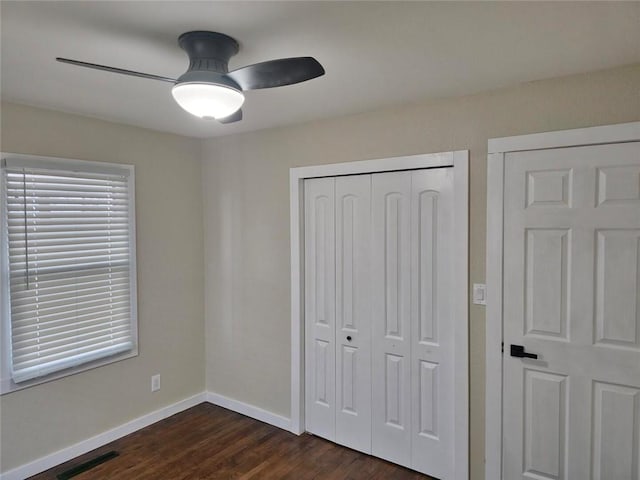 11115 E 35th Ter S, Independence, MO 64052 - unfurnished bedroom with dark wood finished floors, a closet, baseboards, and ceiling fan