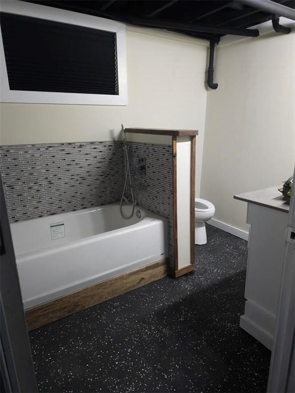 11115 E 35th Ter S, Independence, MO 64052 - bathroom featuring toilet, a tub, vanity, and baseboards