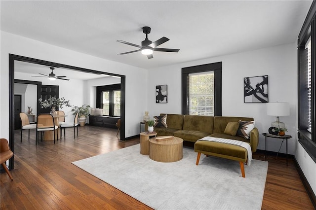 206 SW 22nd St, Blue Springs, MO 64015 - living room with baseboards, a ceiling fan, and dark wood-type flooring