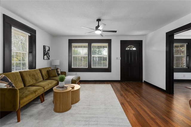 206 SW 22nd St, Blue Springs, MO 64015 - living room with baseboards, a ceiling fan, and wood finished floors
