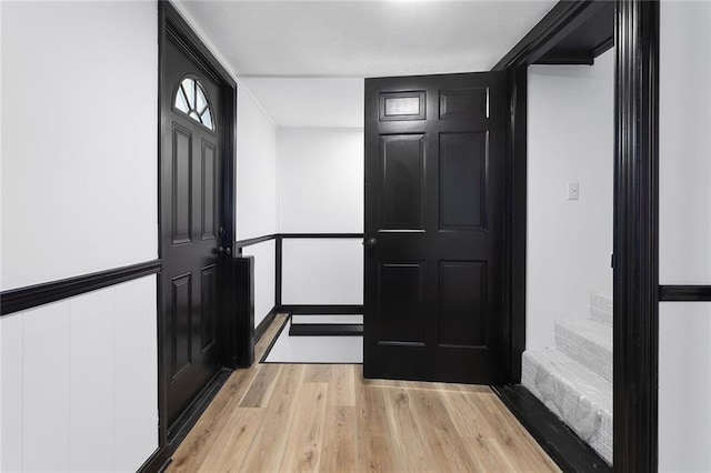 206 SW 22nd St, Blue Springs, MO 64015 - foyer featuring stairway, a decorative wall, and light wood-style floors