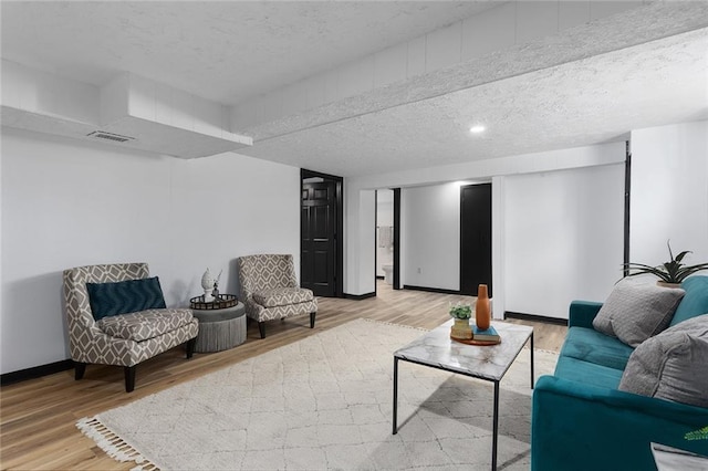 206 SW 22nd St, Blue Springs, MO 64015 - living room featuring baseboards, wood finished floors, and a textured ceiling