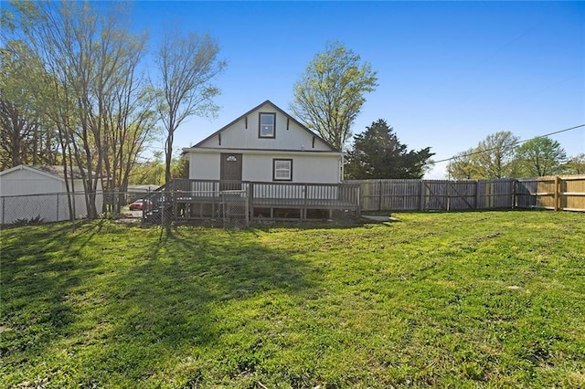 206 SW 22nd St, Blue Springs, MO 64015 - back of property with a wooden deck, a yard, and a fenced backyard