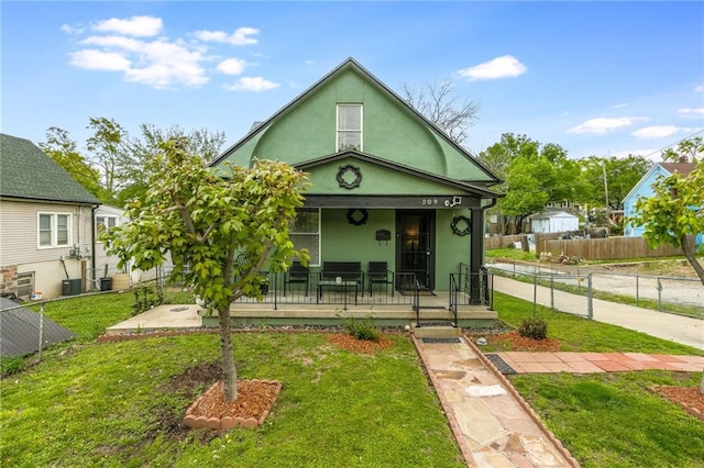 view of front facade featuring a porch, a front lawn, and stucco siding