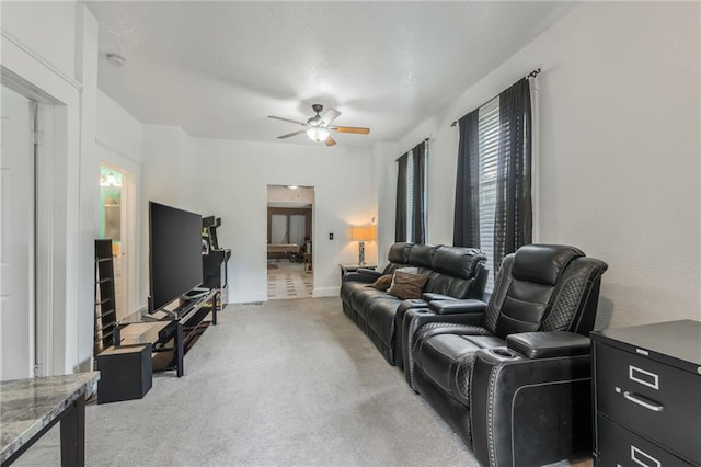 living area featuring a ceiling fan and light carpet