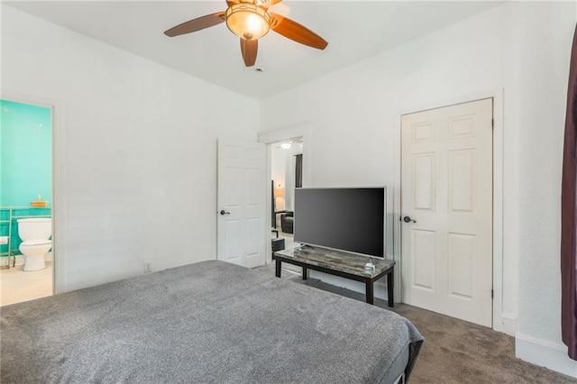 carpeted bedroom featuring ceiling fan and ensuite bath