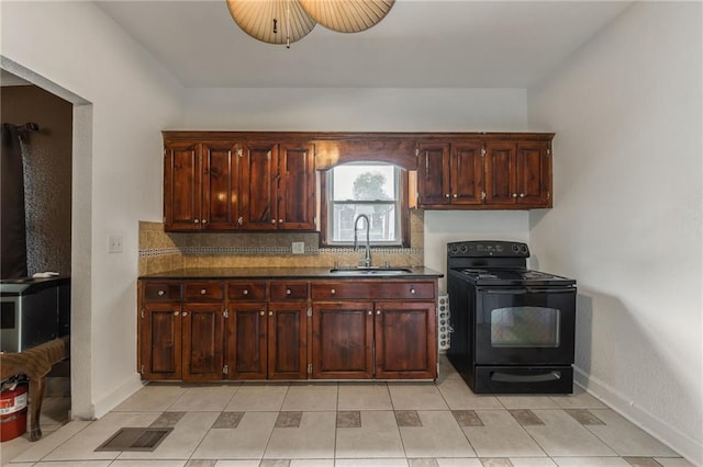 kitchen with visible vents, dark countertops, tasteful backsplash, black range with electric stovetop, and a sink