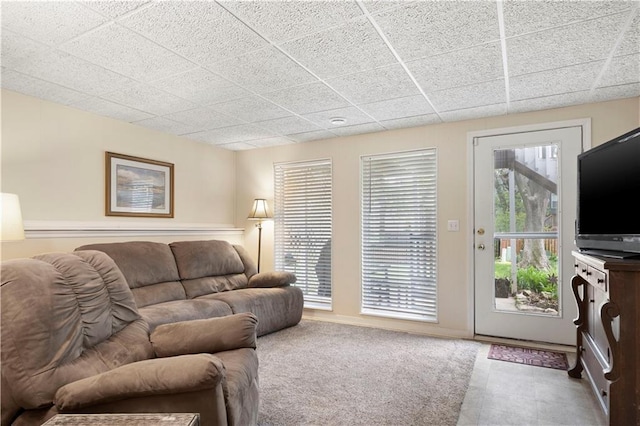 living room with a paneled ceiling
