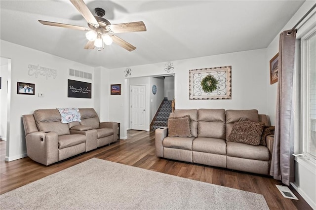living room featuring a ceiling fan, wood finished floors, and visible vents