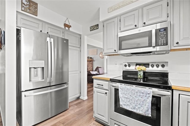 kitchen featuring light countertops, appliances with stainless steel finishes, and light wood-style flooring