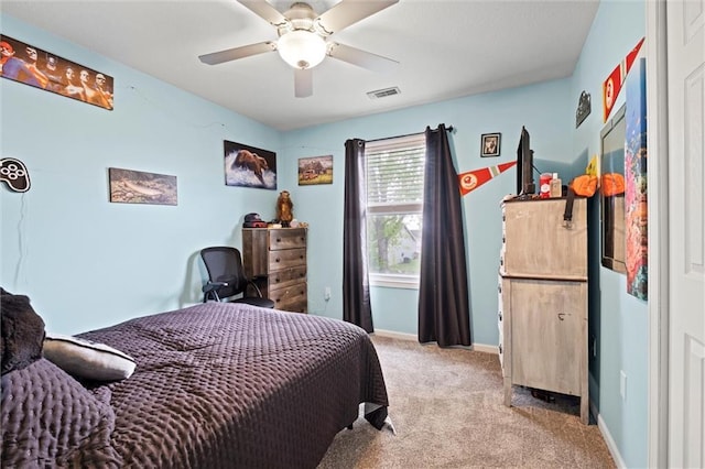 carpeted bedroom featuring baseboards, ceiling fan, and visible vents