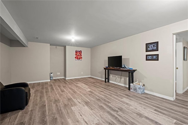 interior space with baseboards and wood finished floors