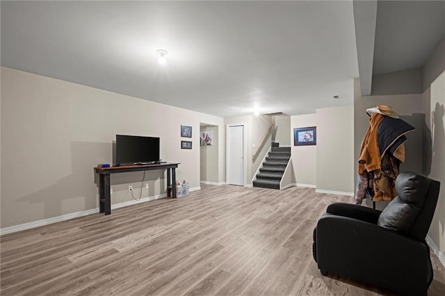 living room with stairway, baseboards, and wood finished floors