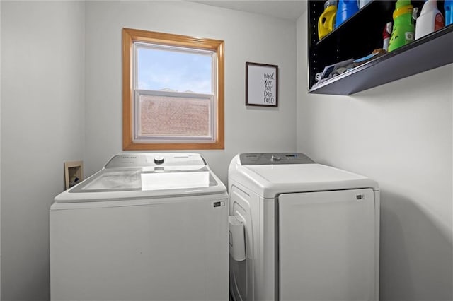 washroom featuring washing machine and clothes dryer and laundry area