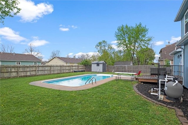 view of swimming pool with an outdoor structure, a wooden deck, a fenced backyard, a storage unit, and a lawn
