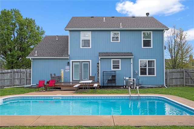 rear view of house featuring a fenced in pool, a shingled roof, a fenced backyard, and french doors