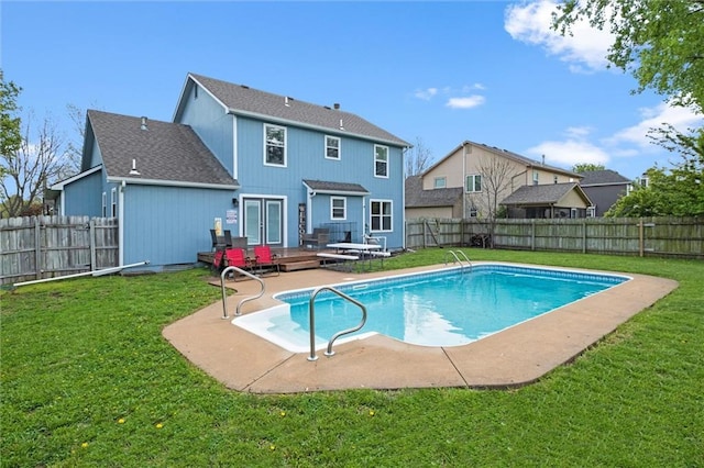 view of swimming pool with a lawn, a fenced backyard, and a patio area