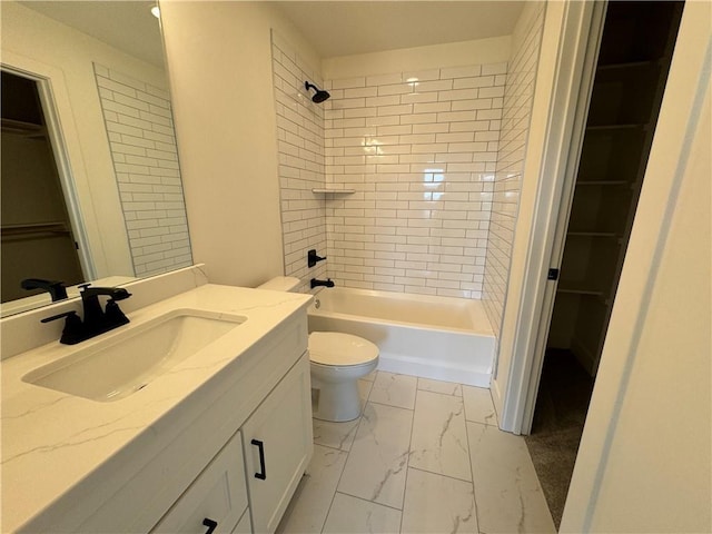 full bathroom featuring a spacious closet, toilet, vanity, and marble finish floor