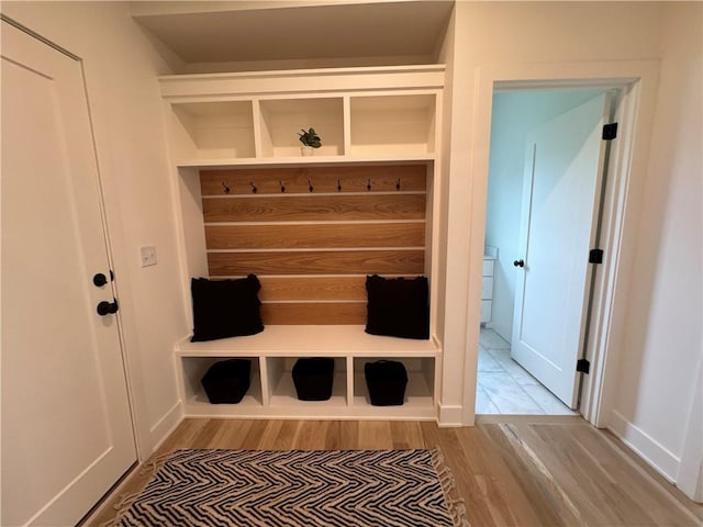 mudroom with baseboards and wood finished floors