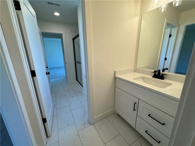 bathroom with a shower stall, marble finish floor, vanity, baseboards, and visible vents