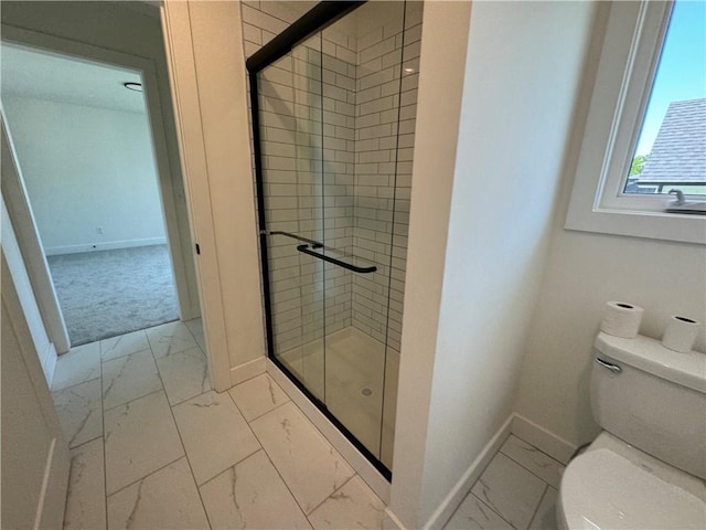 full bathroom featuring toilet, a stall shower, marble finish floor, and baseboards